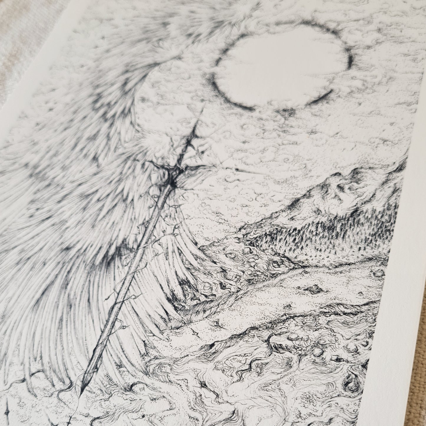 Highly detailed black and white fantasy illustration of a vertical sword entwined with wings, dividing a surreal sky, sun, and mountainous landscape. Hand-drawn in fine ink lines, evoking mythic and celestial themes with gothic and ethereal elements.